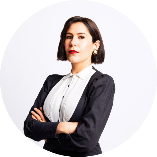 Jan Fran is wearing black and white and standing with her arms crossed.