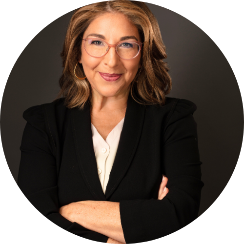 Portrait of Naomi Klein smiling with arms folded.