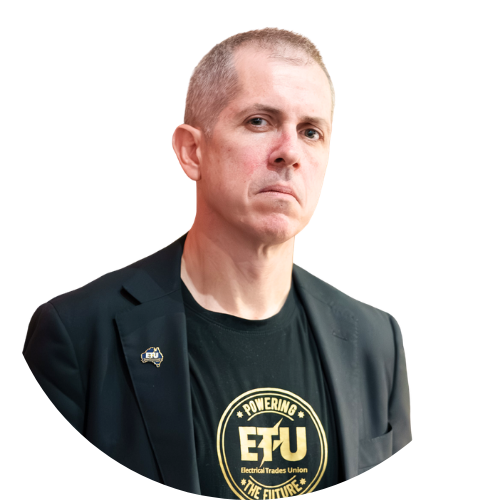 Michael Wright facing the camera, wearing a black shirt that says 'ETU: Powering the Future'