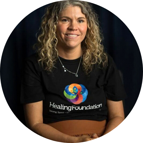 Portrait of Shannan Dodson wearing a black "Healing Foundation" shirt