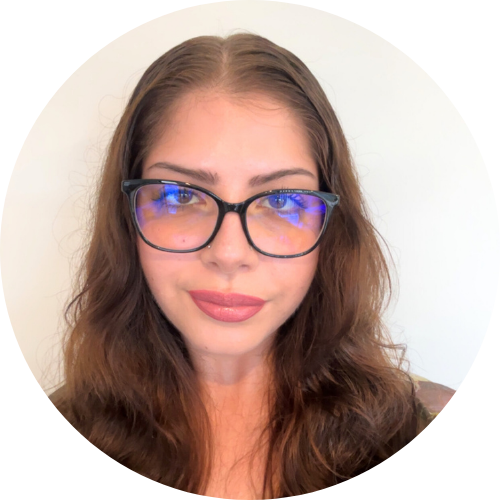 Image of Lauren smiling she has long brown hair and is wearing glasses.