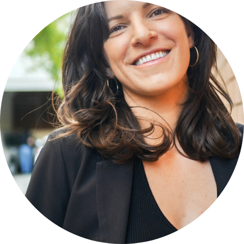 Portrait of Coco Venaglia standing outside, smiling.