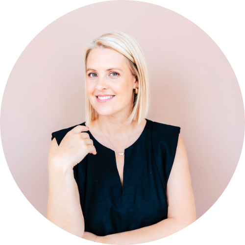 Georgie Dent - a white woman with blonde hair, standing against a pale pink background.
