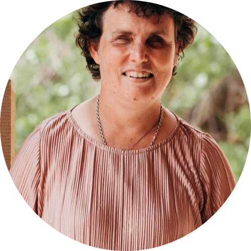 Portrait of Emma Bennison smiling at the camera, wearing a light pink shirt