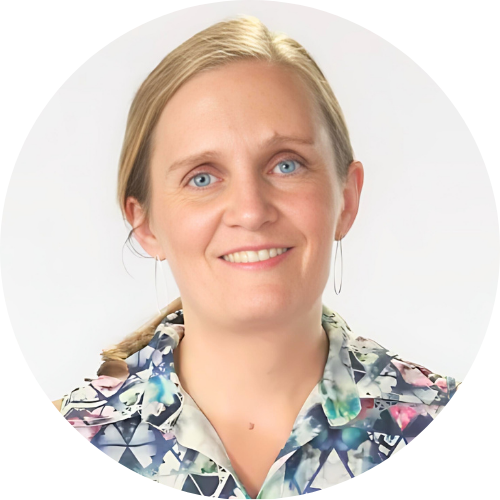 Portrait of Freya, a white woman with long hair in a pony tail and a wearing shift.