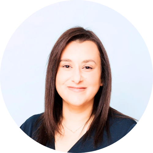 Maiy Azize smiling, facing the camera wearing a black shirt.