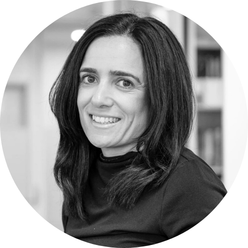 A black and white photo of Caterina Georgi smiling, facing the camera.