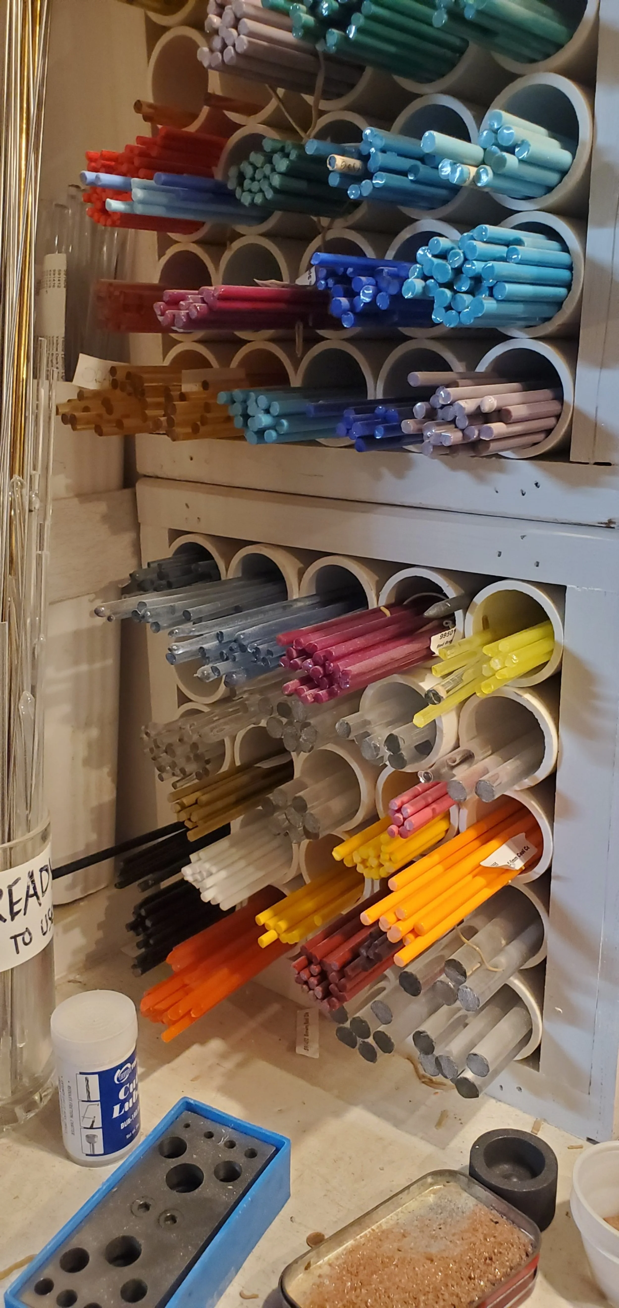 Glass rods at the ready for lampworking or glass blowing.  The top of your head will peel off and radioactive termites of though will pour forth!