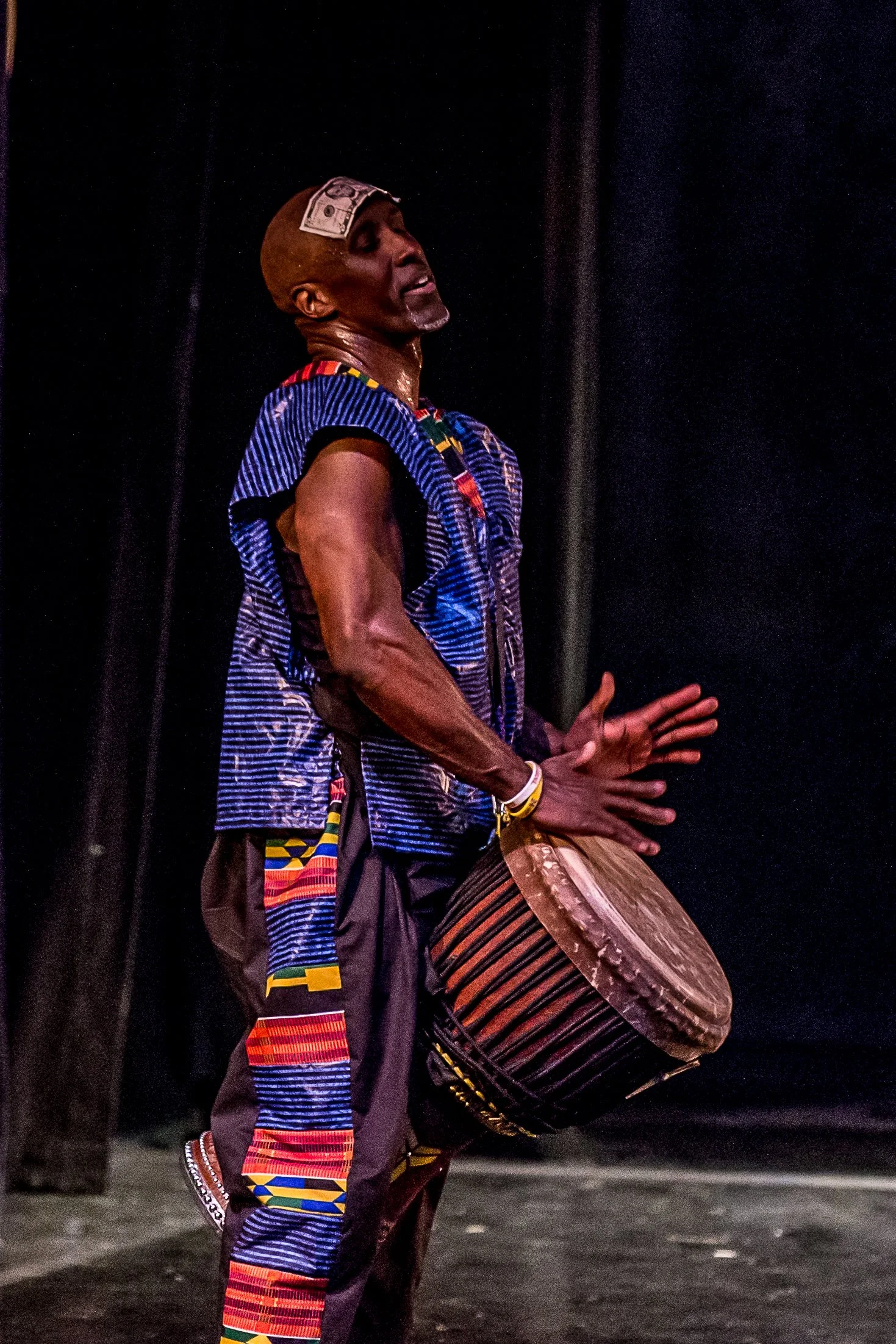 Derrell drumming dollar on head.jpg