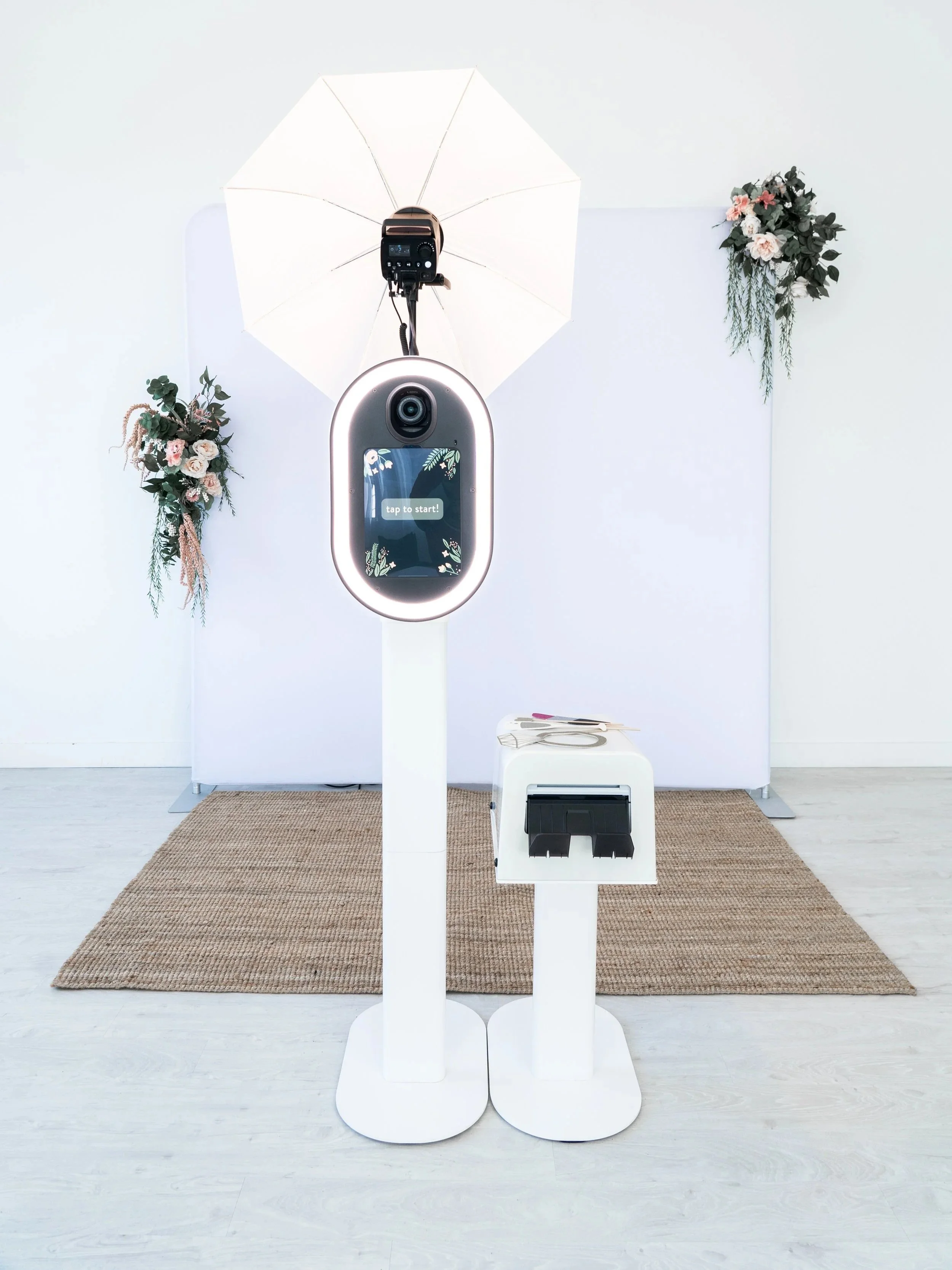 Photo booth rental setup from Booth & Bash Co. PRO Booth producing on-site event prints in Jackson, Tennessee. Shows wedding and event entertainment service with unlimited digital captures and custom overlays.