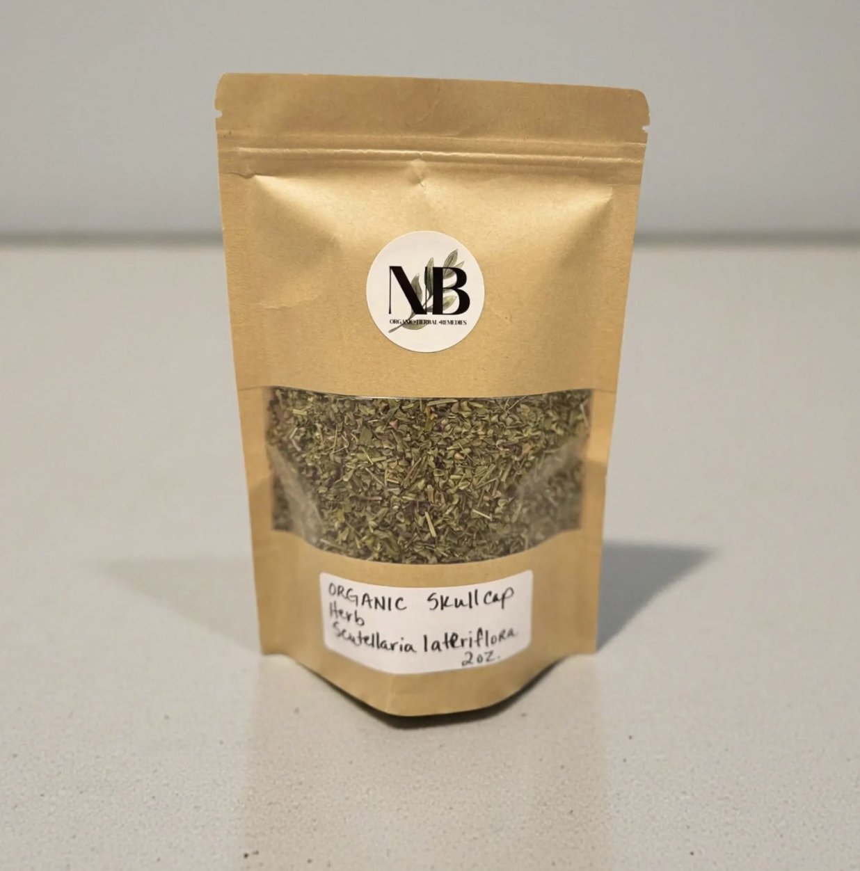 Stand-up pouch of organic skullcap herb, cut and sifted, on neutral background