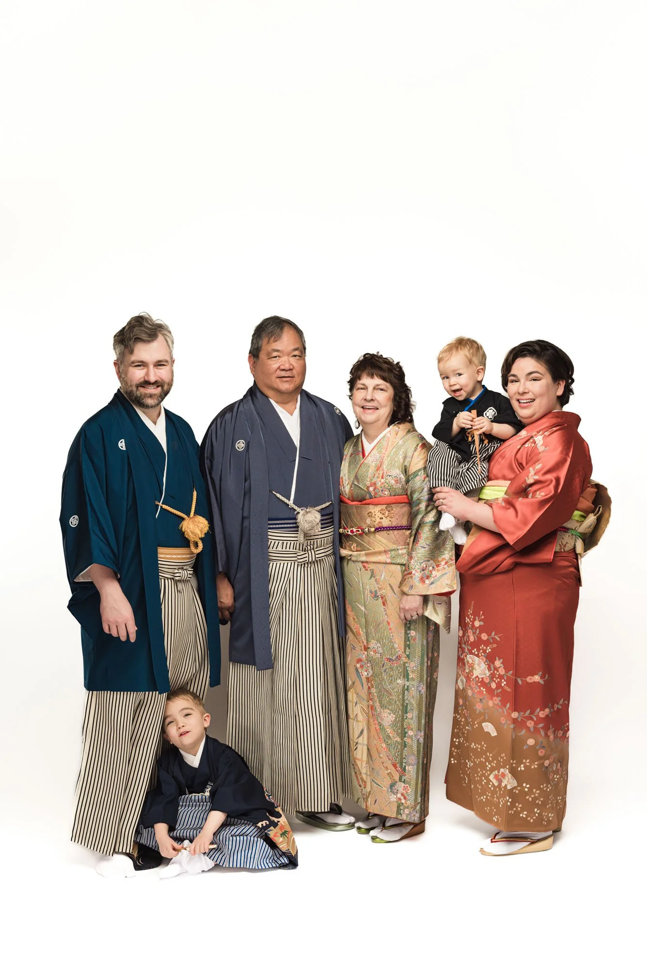Multi-generational family in Japanese kimono including grandparents, parents, and children, clean studio portrait – Seattle extended family kimono photography