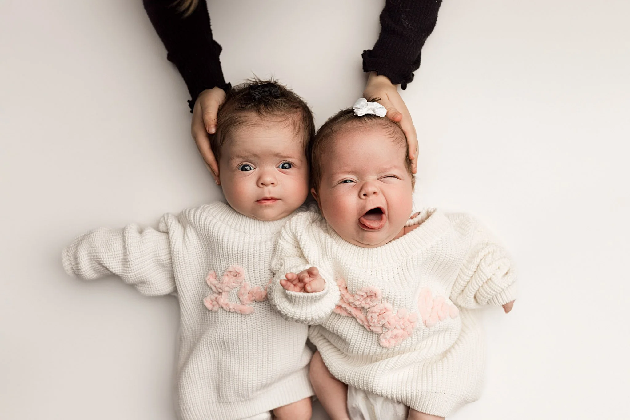 Twin newborn baby portrait in soft neutral tones photographed by Seattle newborn photographer Atsumi Sullivan, serving Bellevue, Tacoma, and surrounding areas