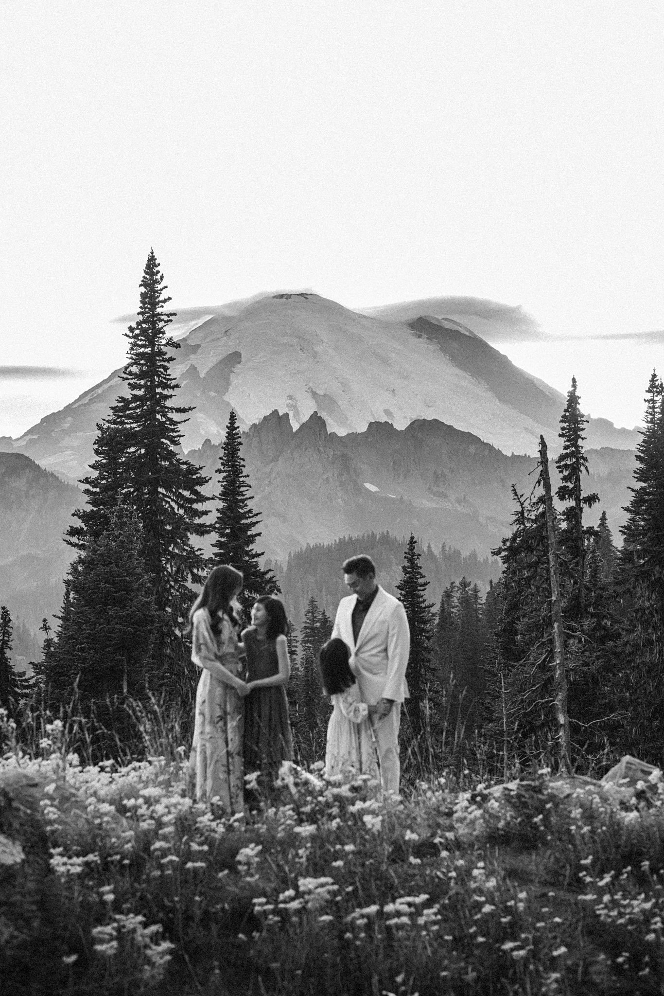 Family portrait session in wildflower meadow with Mount Rainier in the background, photographed by Seattle and Bellevue family photographer Atsumi Sullivan Photography.