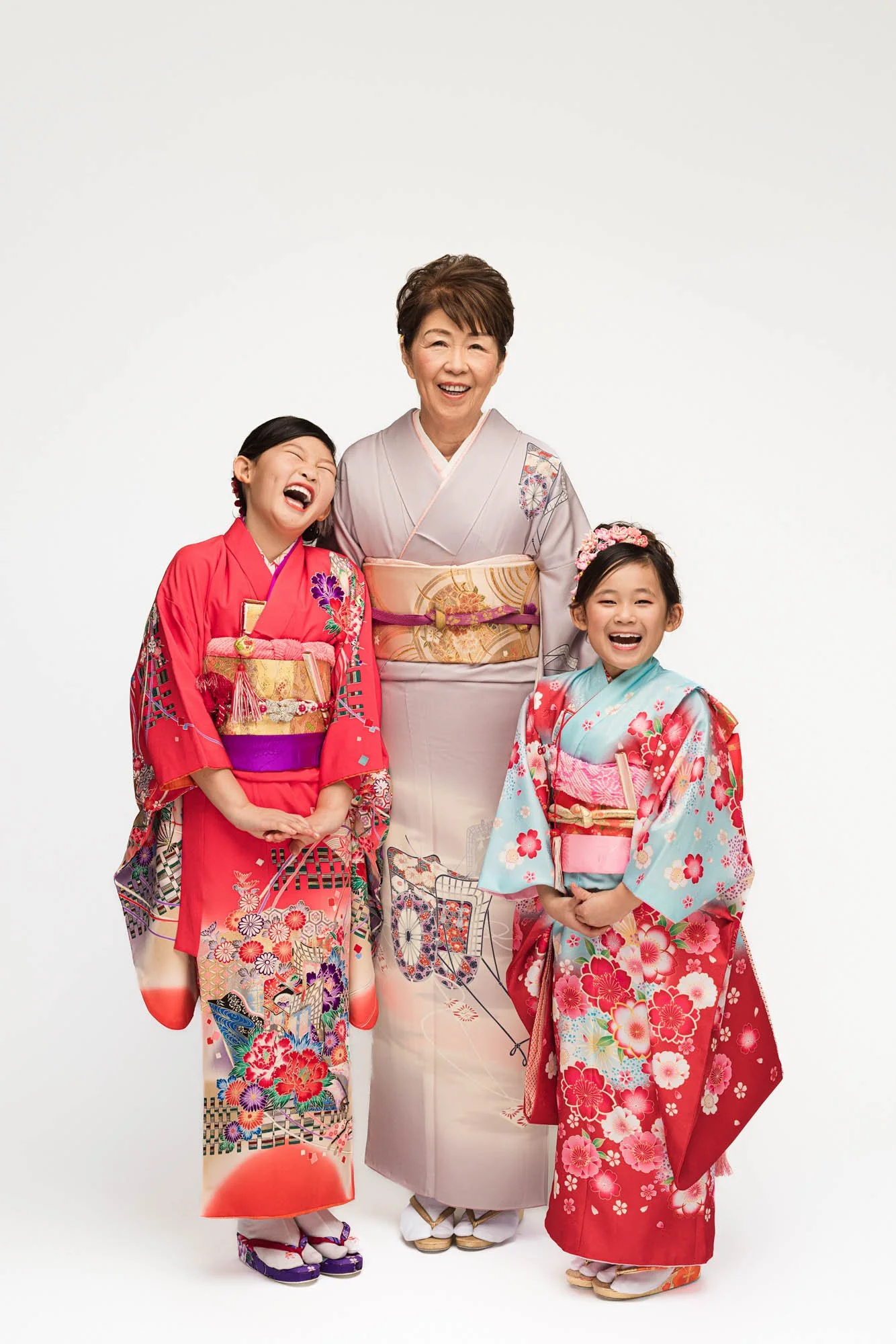 Grandmother and two young girls wearing traditional kimono during a Shichigosan portrait session in a Seattle studio.