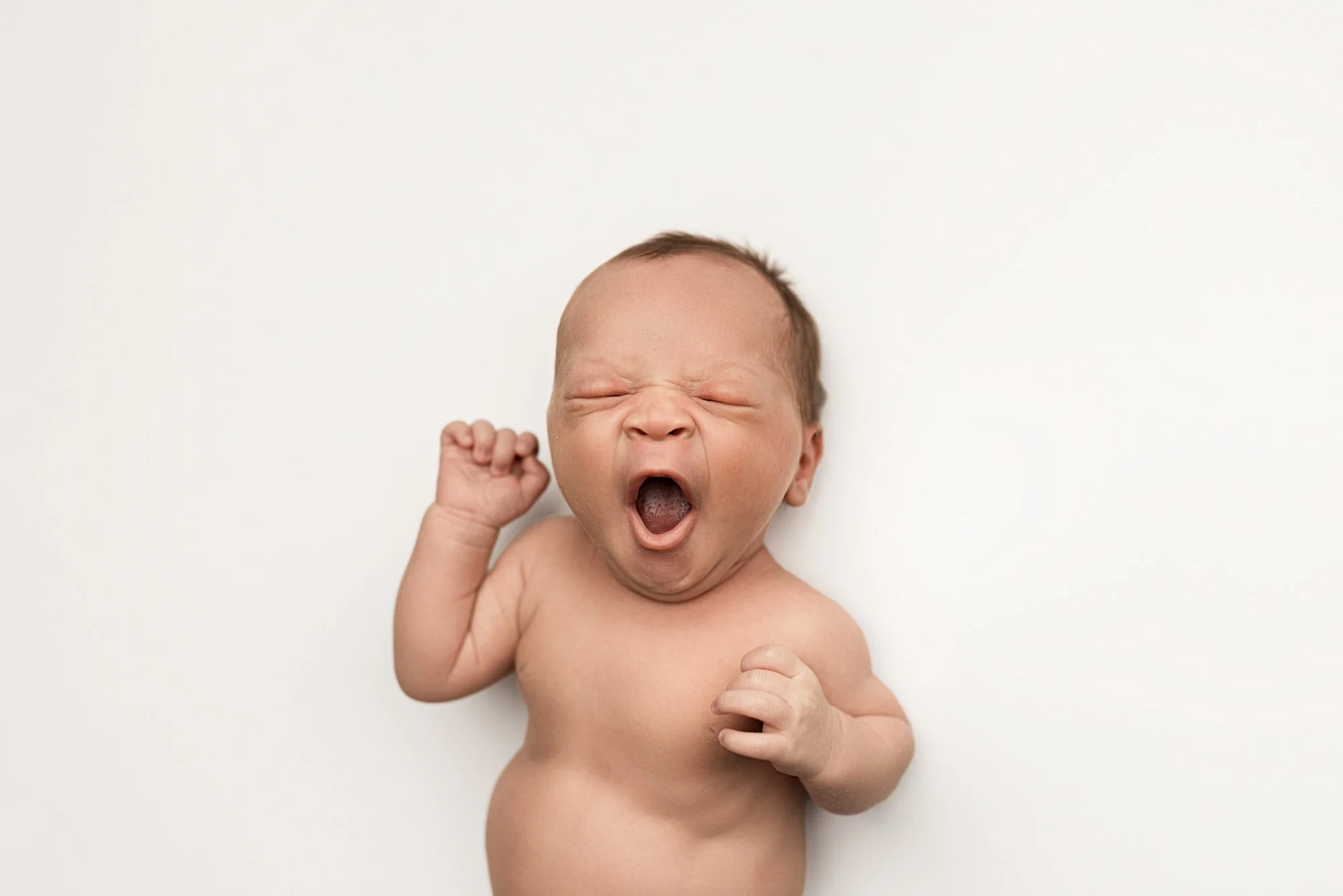 25-day-old newborn baby yawning during a Seattle newborn photography session