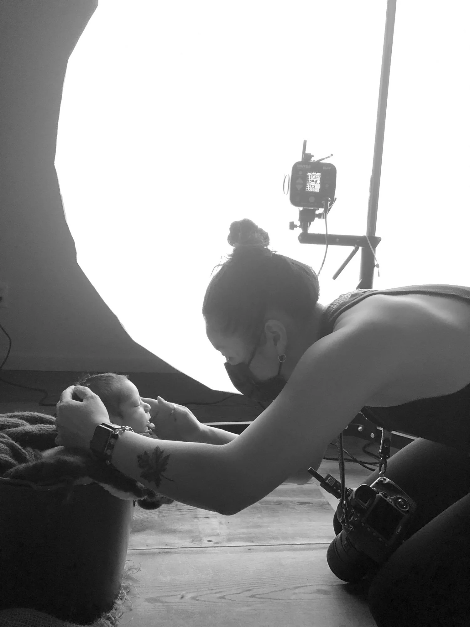 Atsumi Sullivan photographing a newborn baby in her Lake Tapps photography studio
