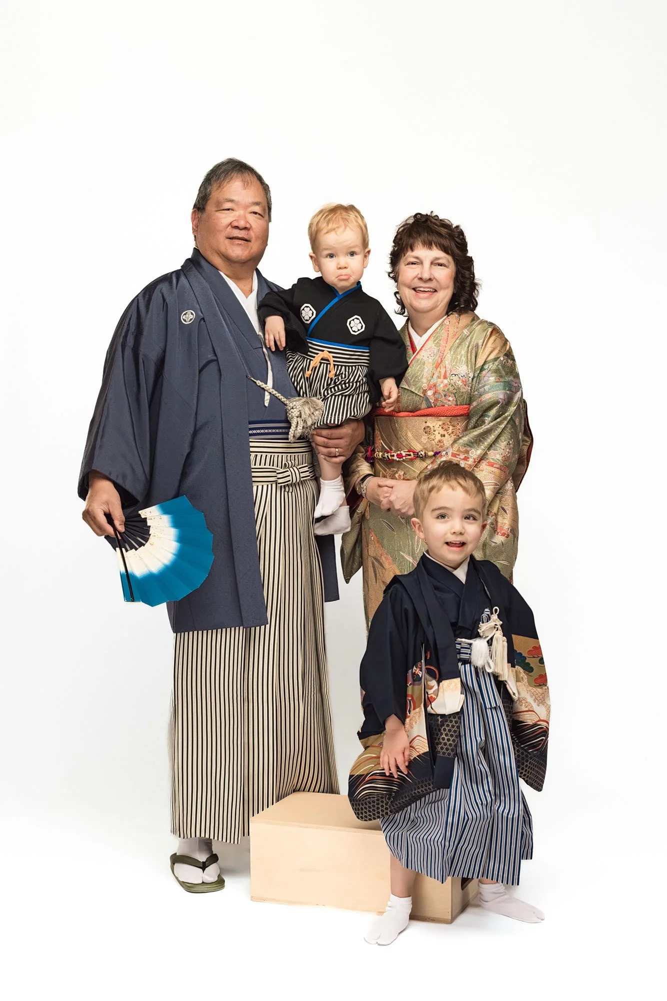 Grandparents with grandchildren dressed in traditional kimono, elegant studio portrait capturing family connection – Seattle kimono photography session