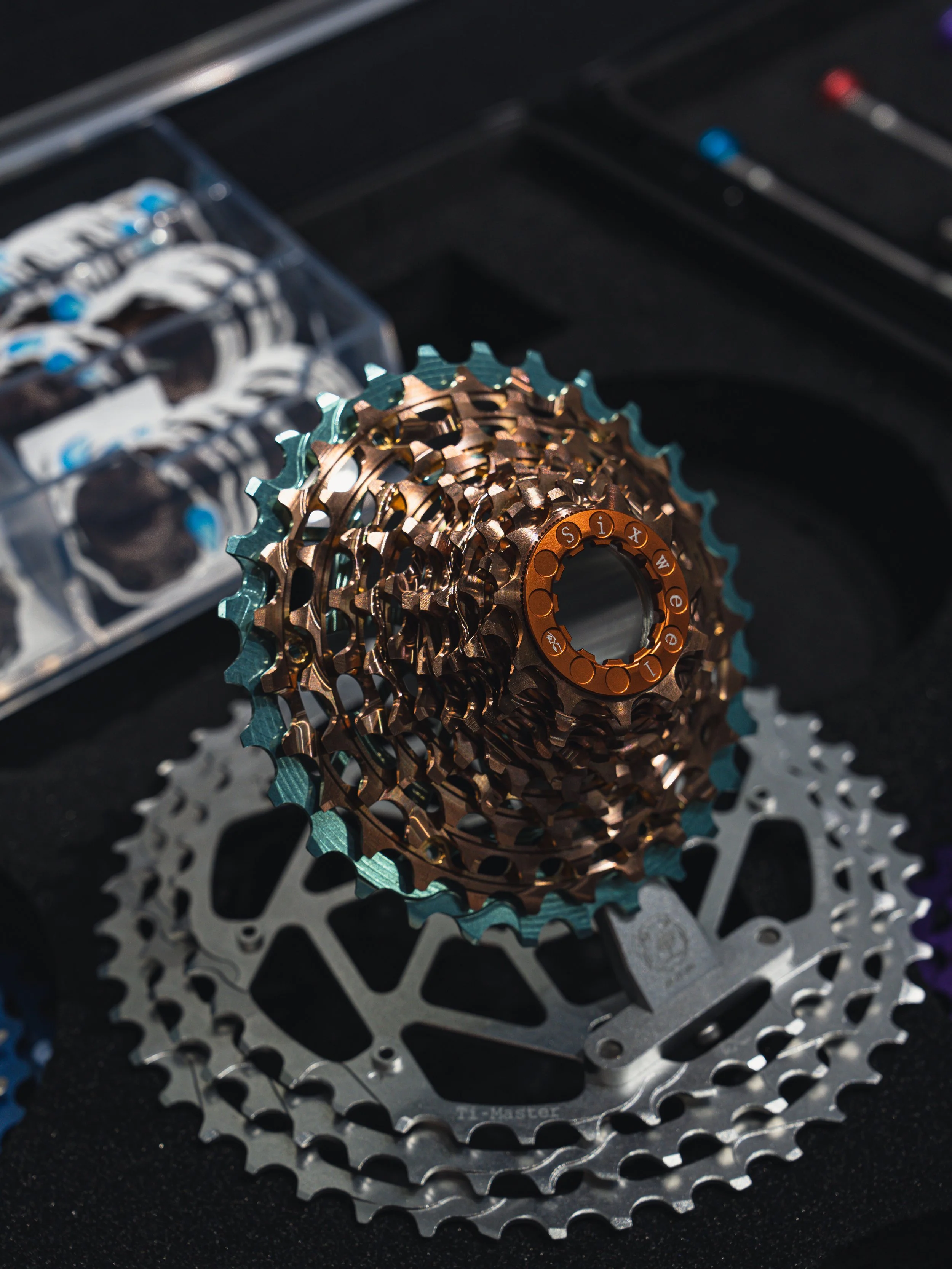 Close-up of bicycle cassette sprockets with multiple gears in metallic and copper colors.