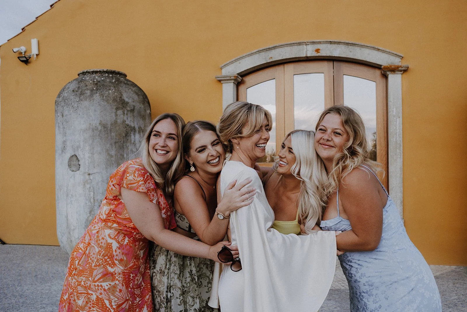Bride laughing with bridesmaids at Solar do Paço wedding venue