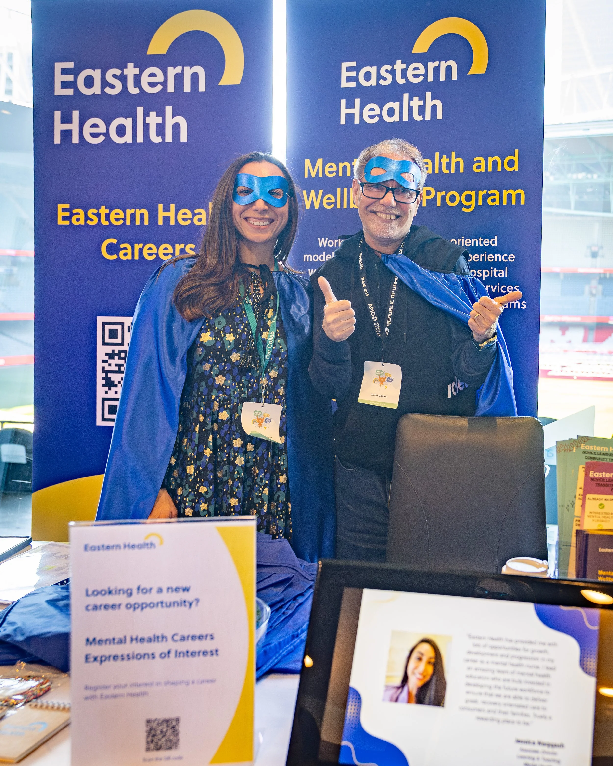 A colour image of people at a stall at a business event