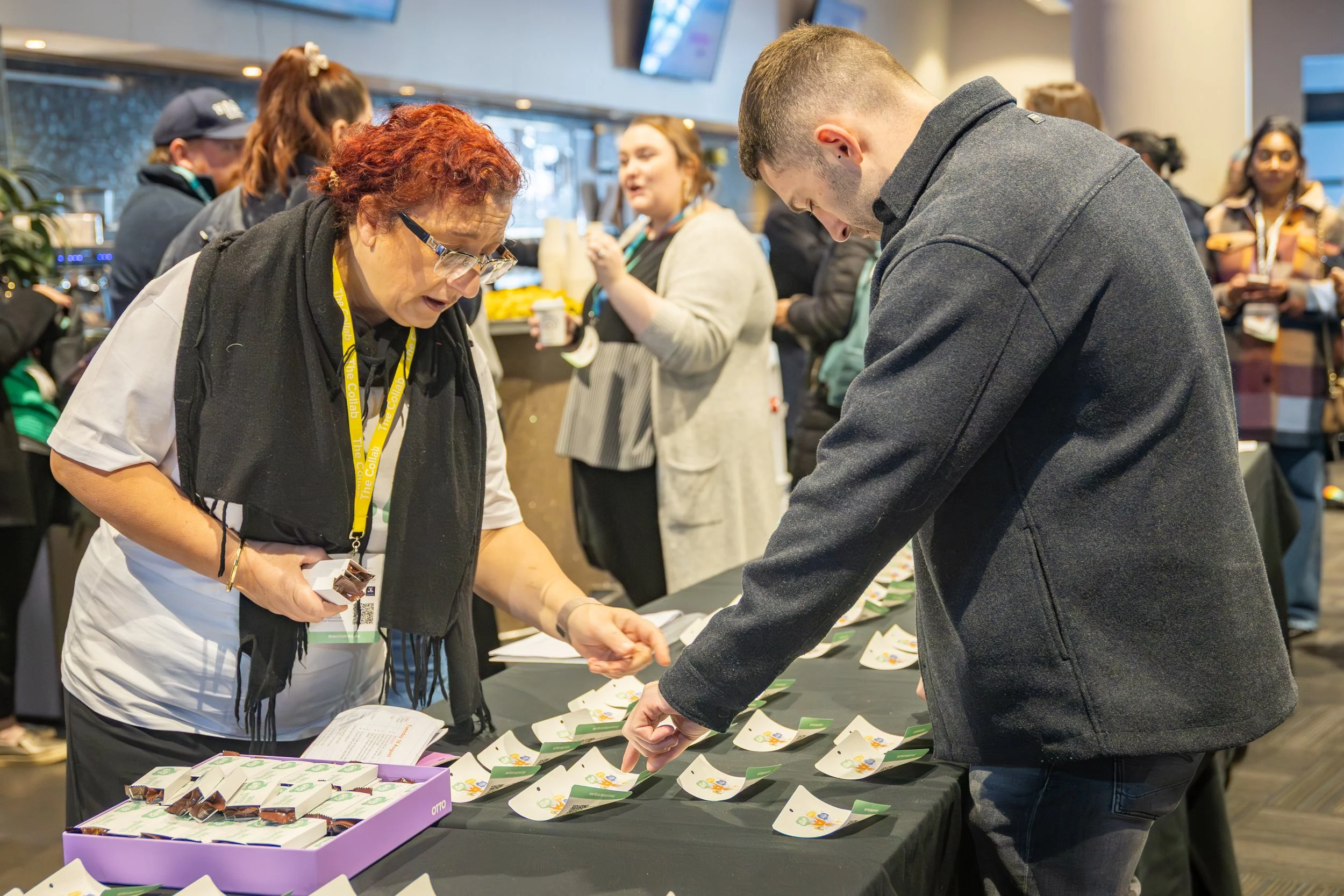 People sorting identification tags at a business event