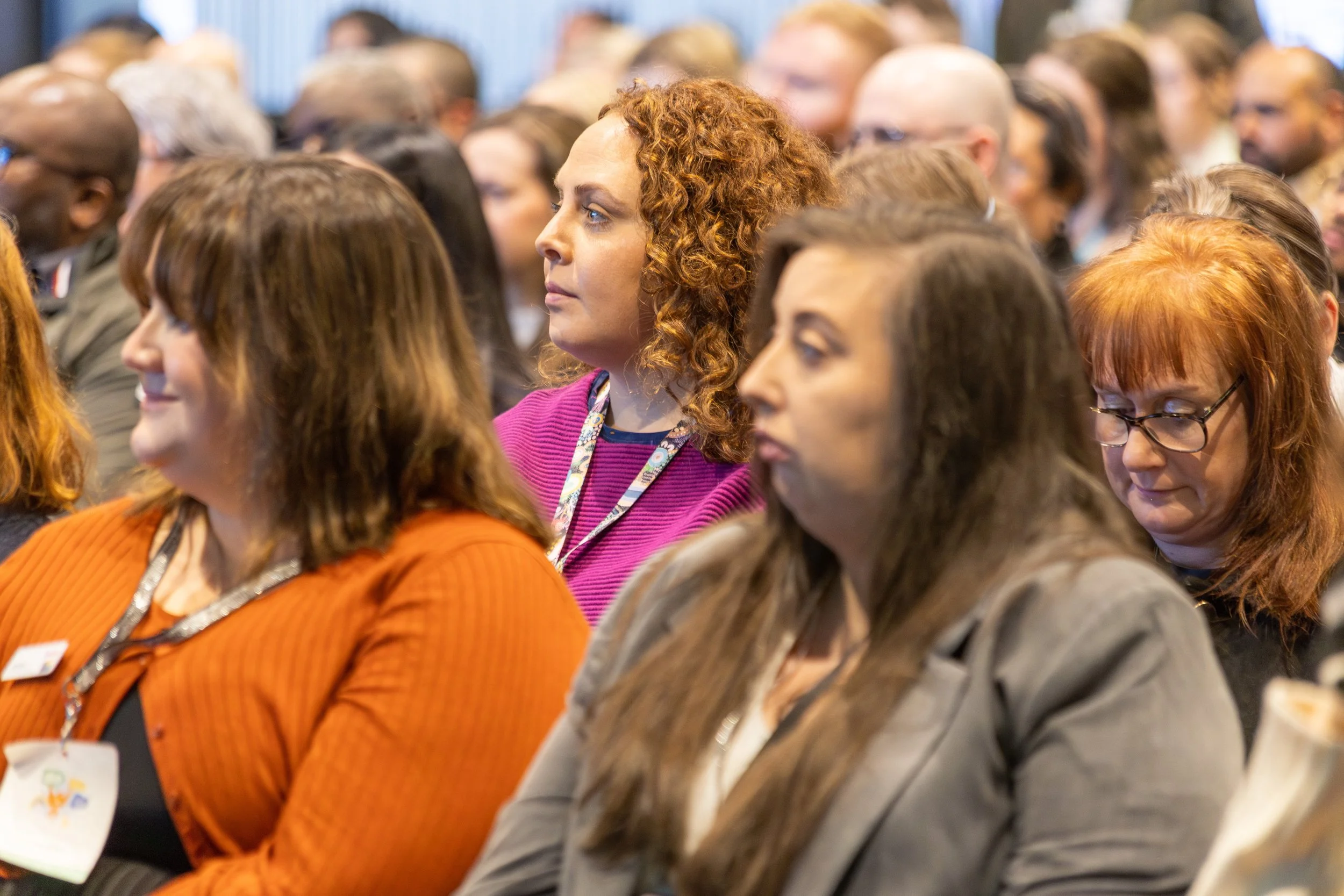 A close up of audience members at a business event