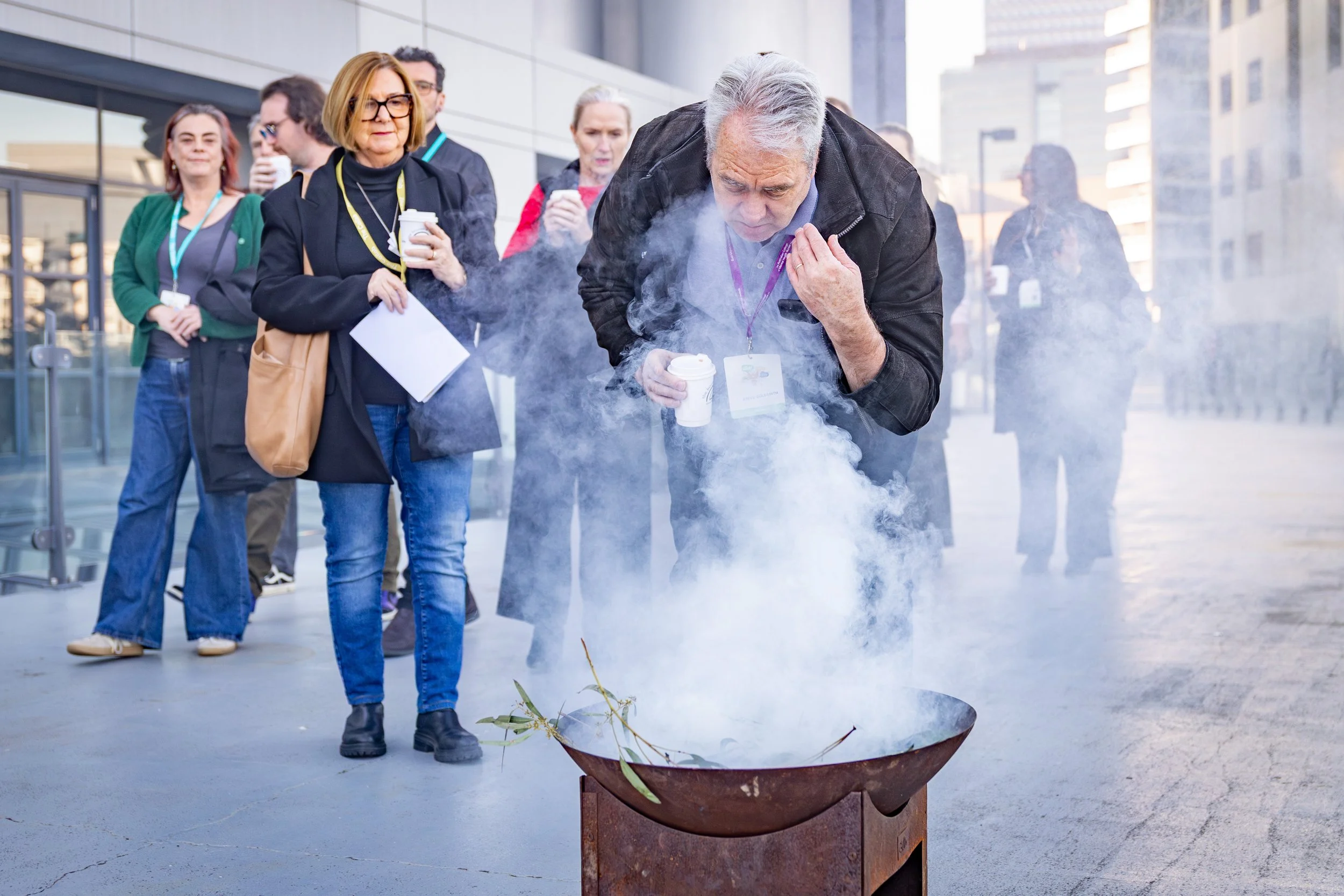 Participants of an indigenous smoking ceremony at a business event