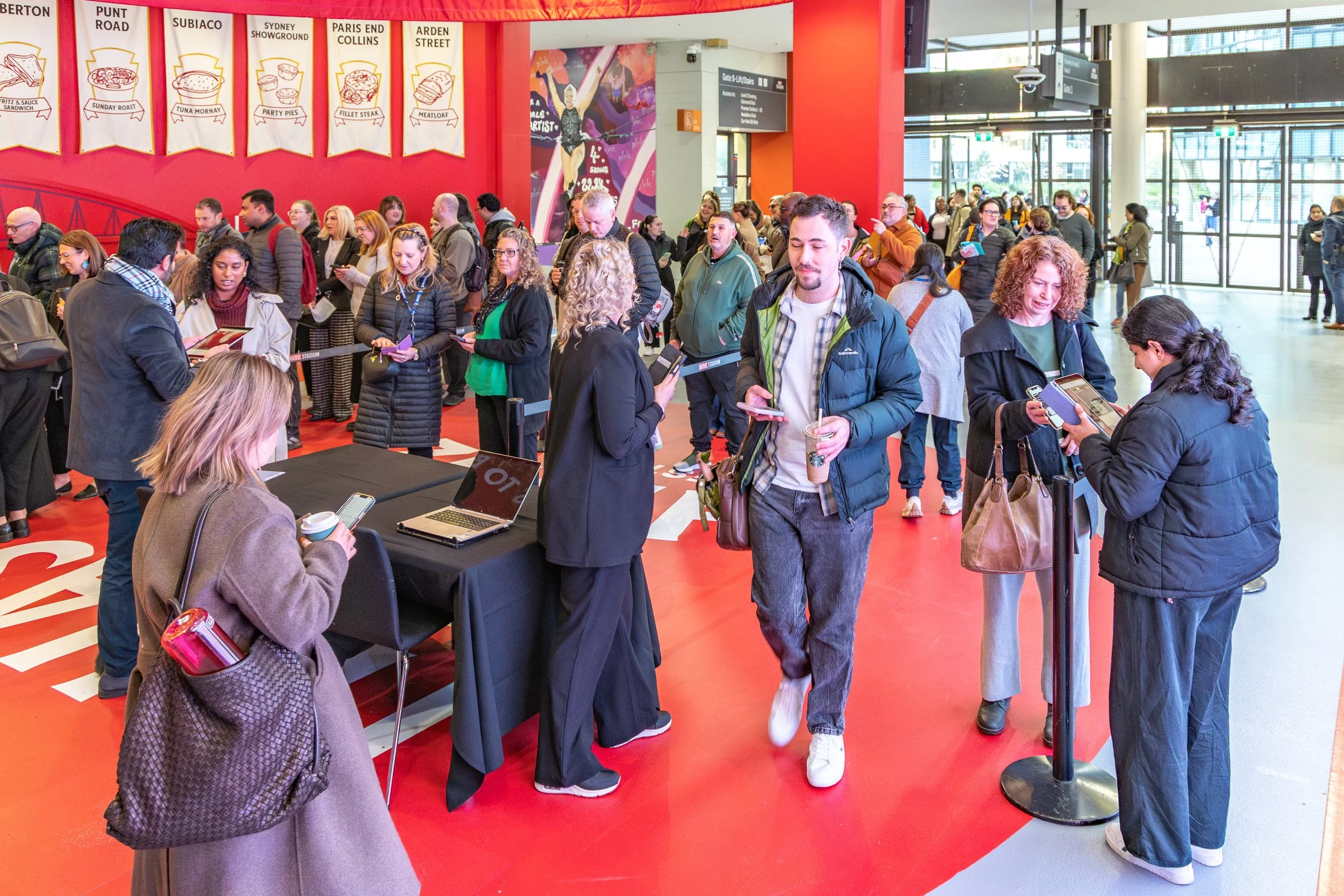A colour image of a crowd registering at a business conference