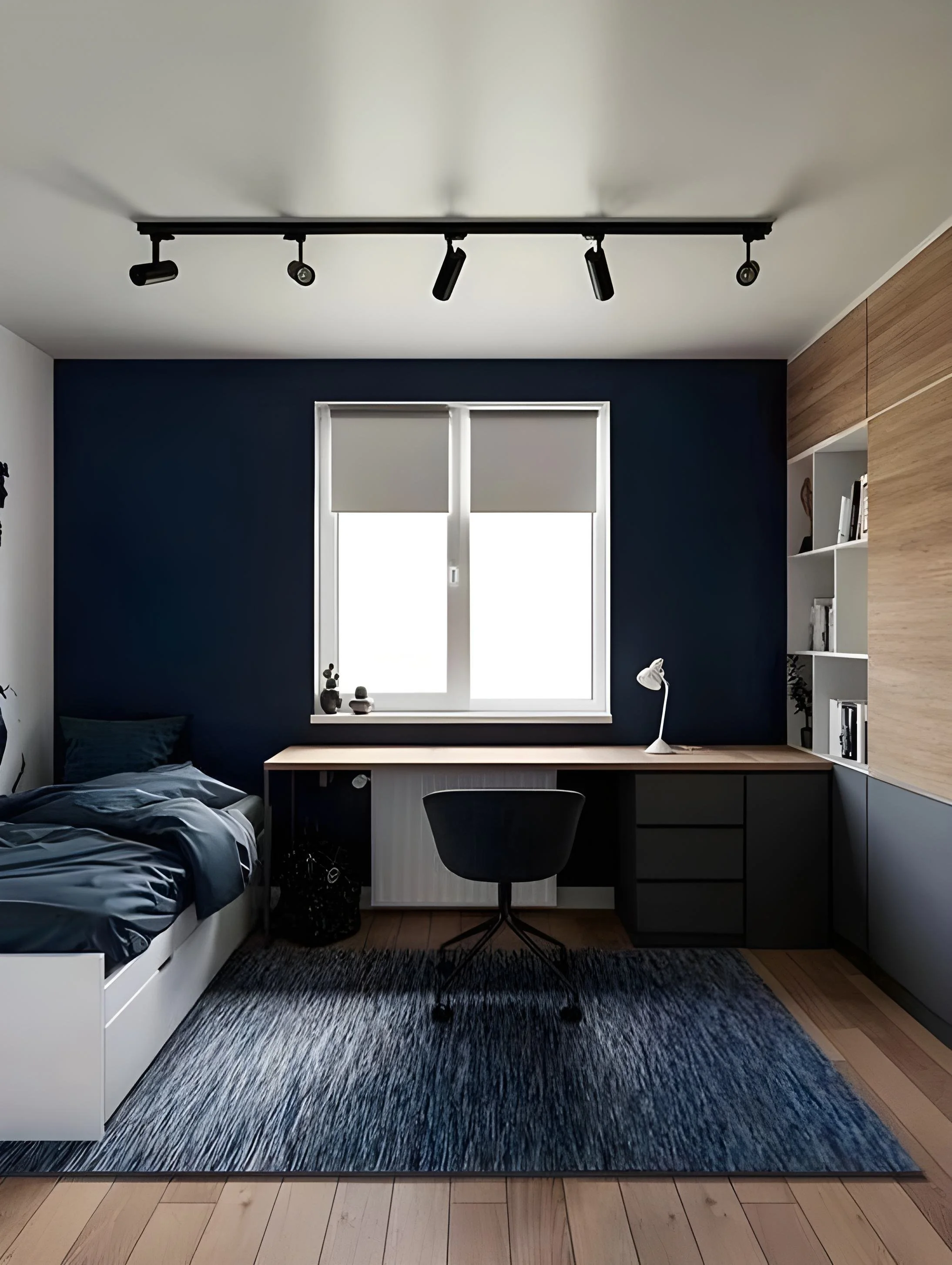 A modern bedroom with a dark accent wall, a window with white blinds, a desk with a chair, a bed with dark bedding, a black and gray rug, and built-in shelving with books.