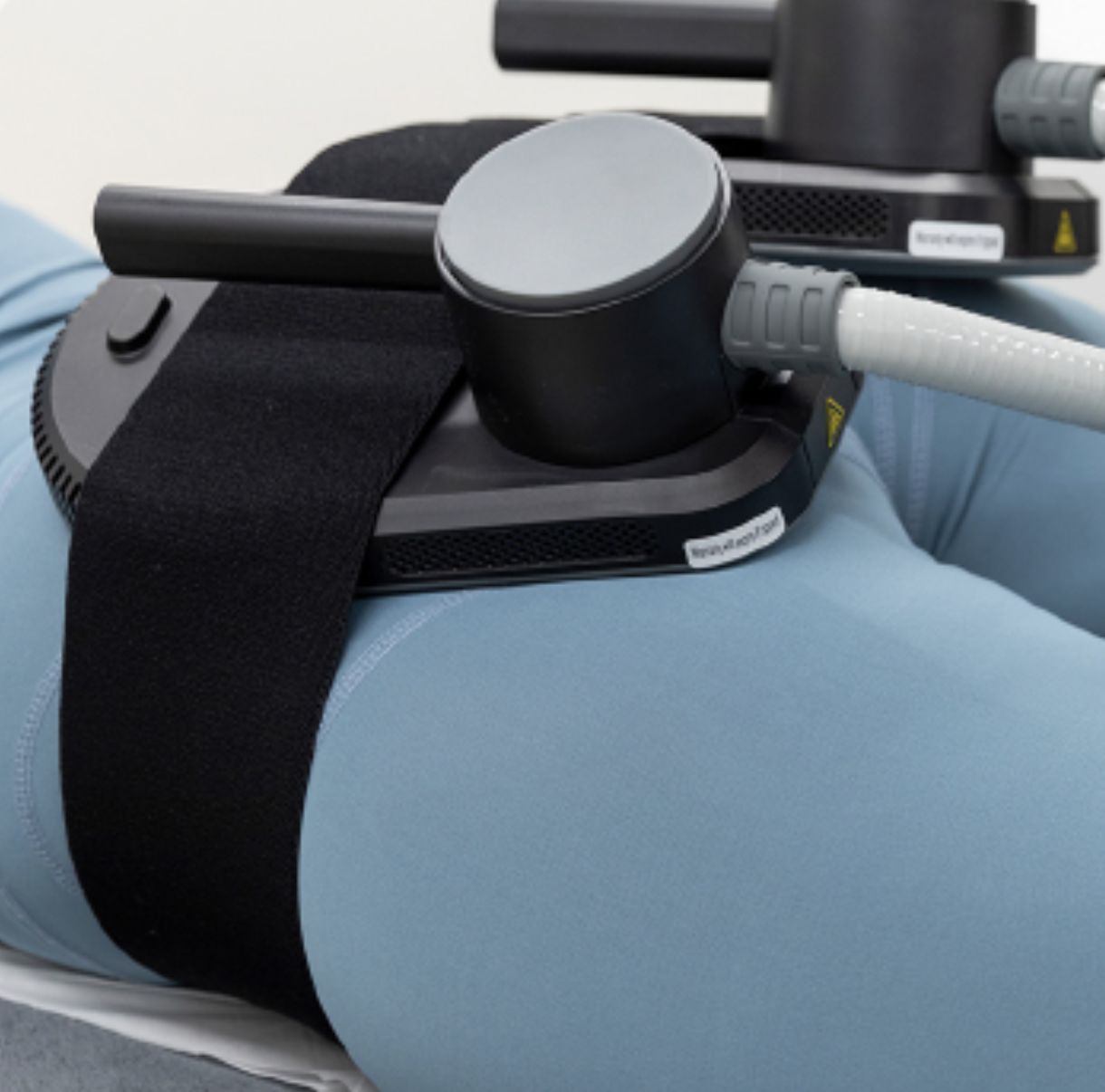 Medical professional undergoing a physical therapy session using a specialized medical device with straps and tubes.