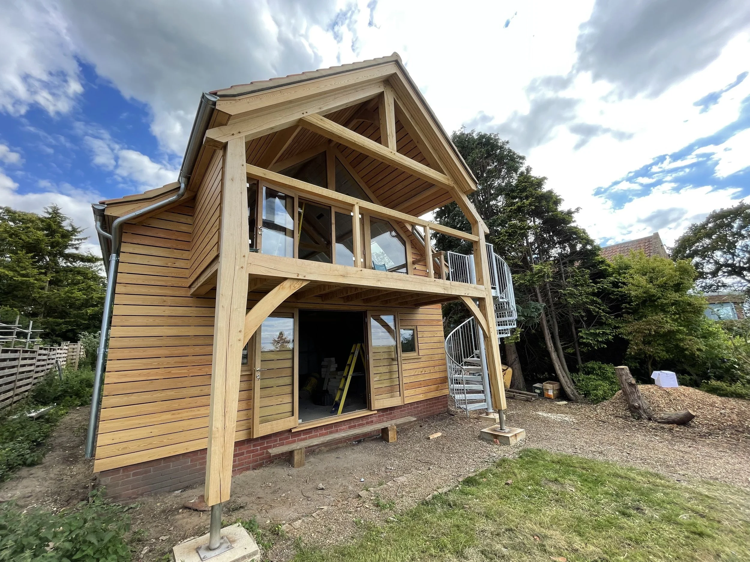 First floor extended covered balcony with spiral star access to garden