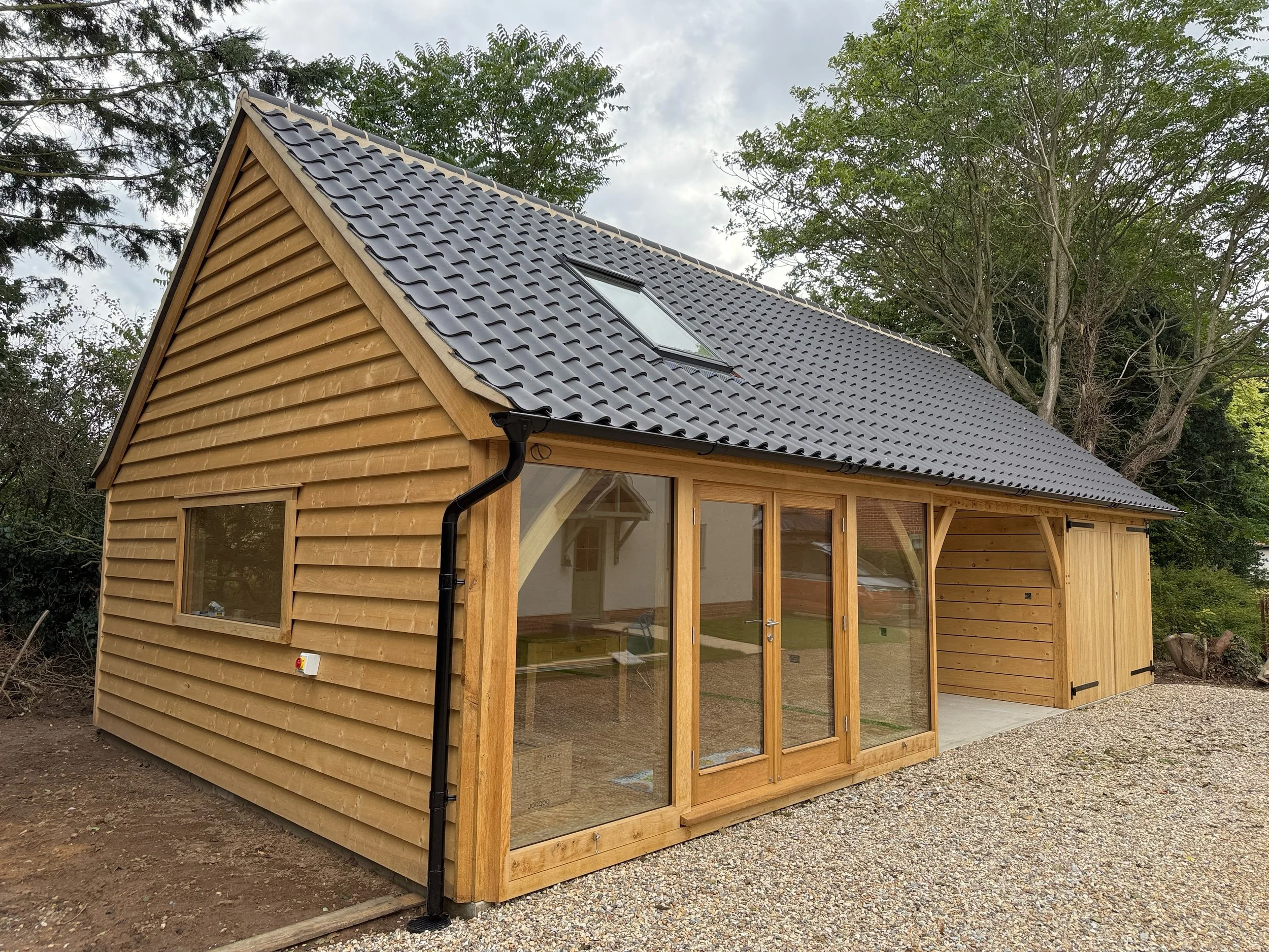 Oak two bay garage with studio