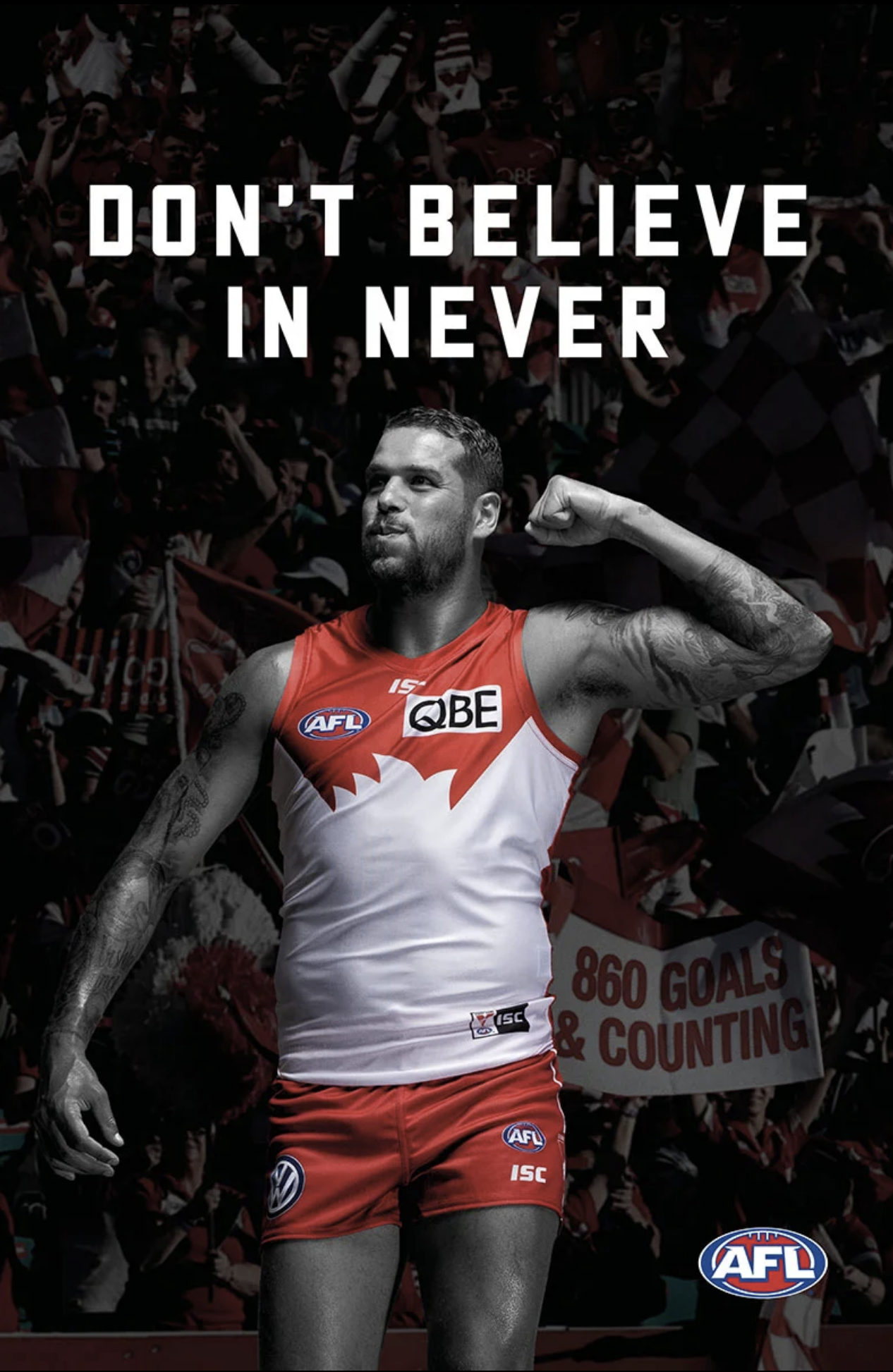 Australian rules football player in red and white uniform with tattoos, standing in front of a crowd holding a sign that says '860 GOALS & COUNTING'.