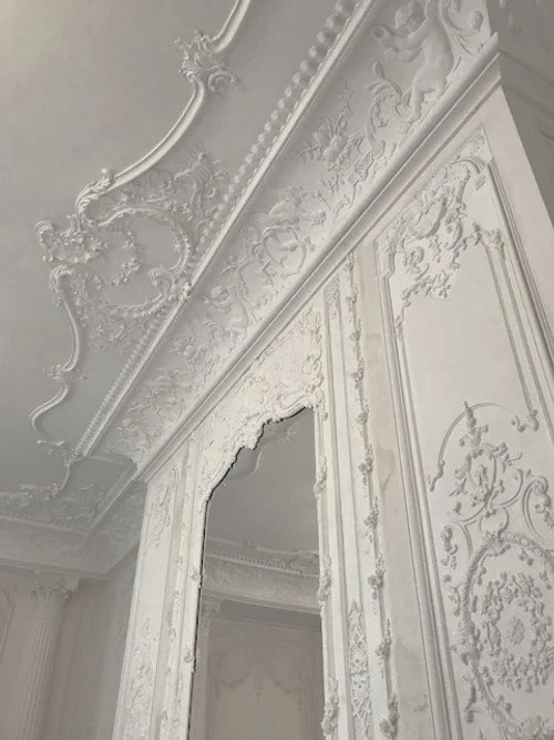 Plafond et murs décorés en style rococo blanc avec moulures ornementales