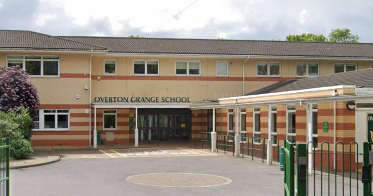 Front view of Overton Grange School building with a parking lot in the foreground, surrounded by greenery.