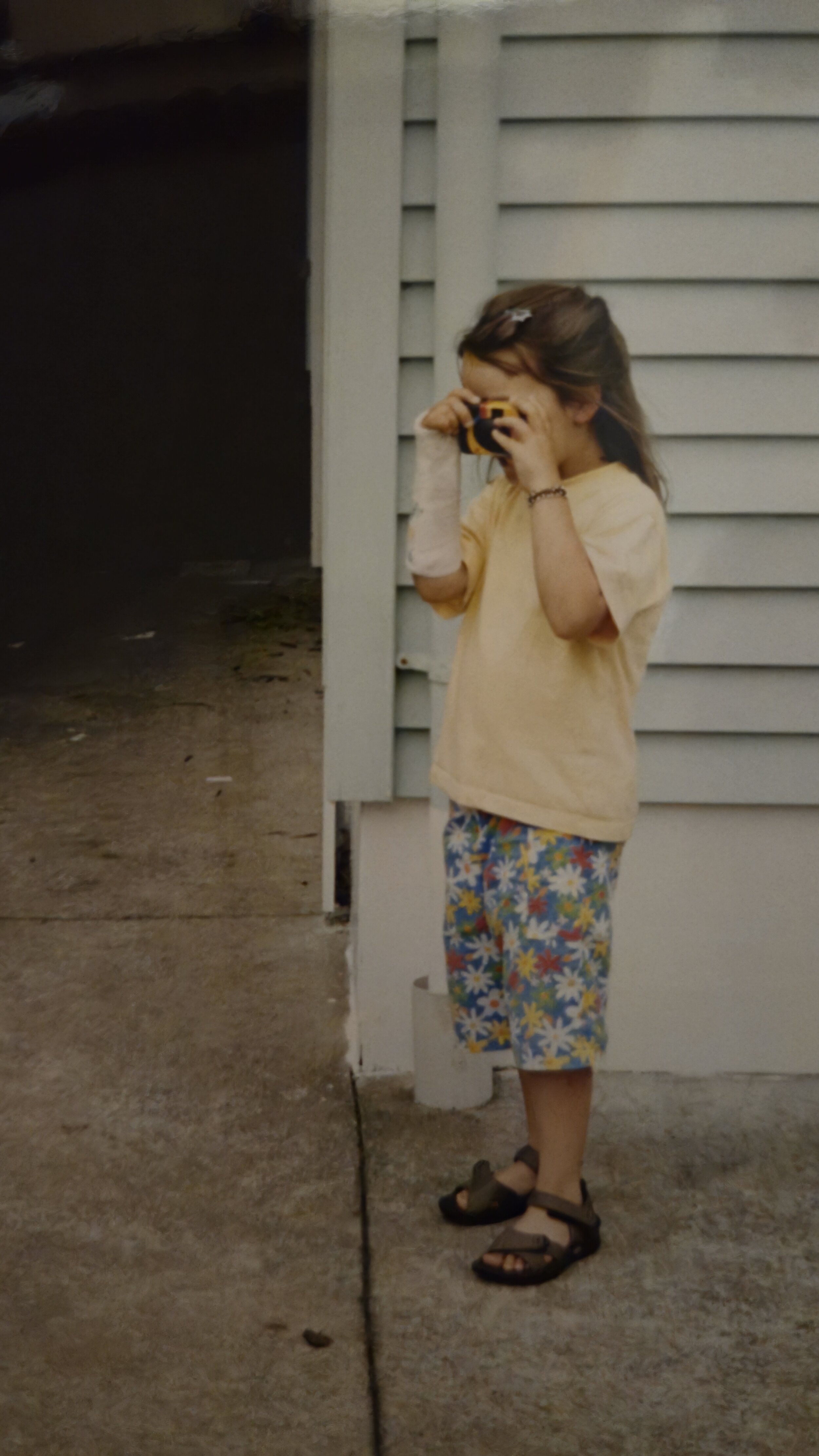 Photo of young Em Boyle using a camera