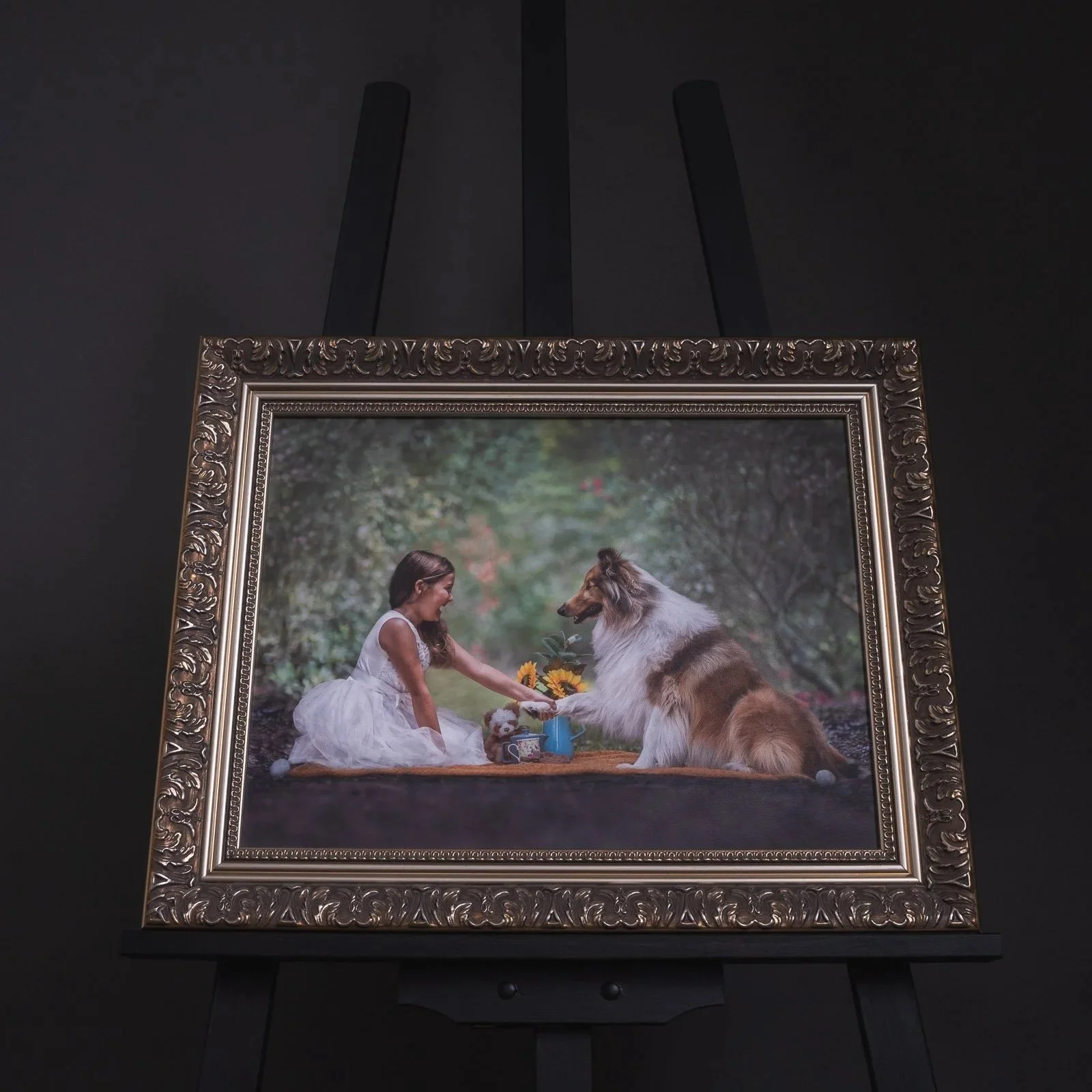 Framed canvas of dog and girl tea party in fine art photography style housed in a gold ornate frame by Em Boyle Photography