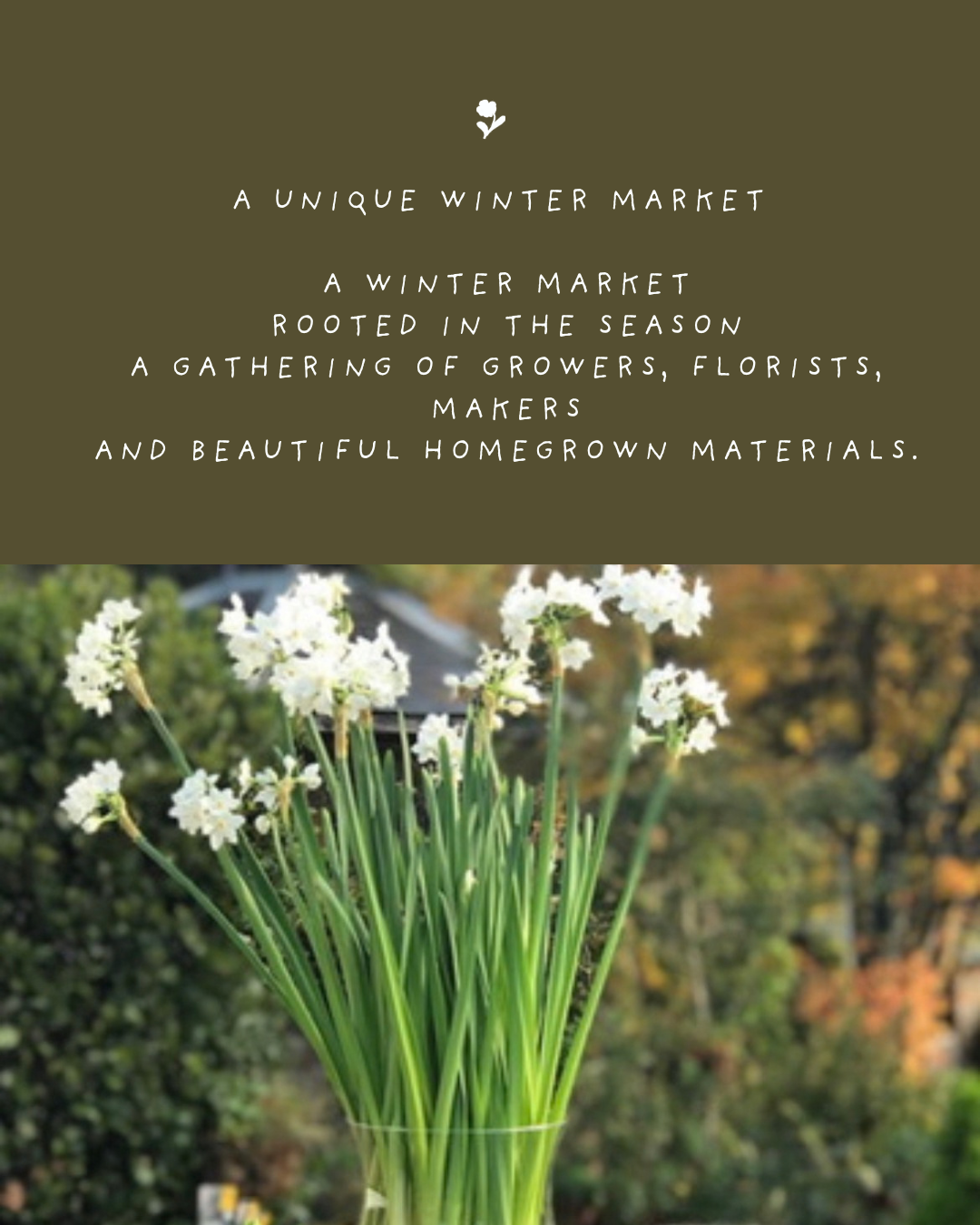A decorative sign with message about a winter market and a photo of white flowers in a glass vase outdoors.