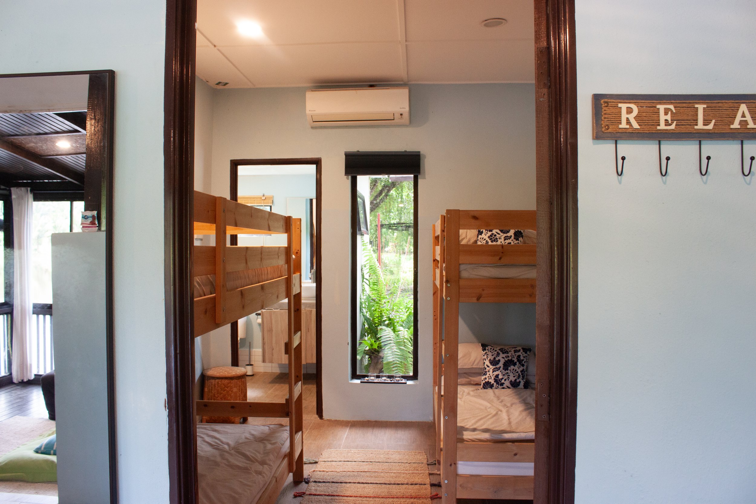 Two single bunk beds situated in the second room with air conditioning and access to the bathroom and shower.