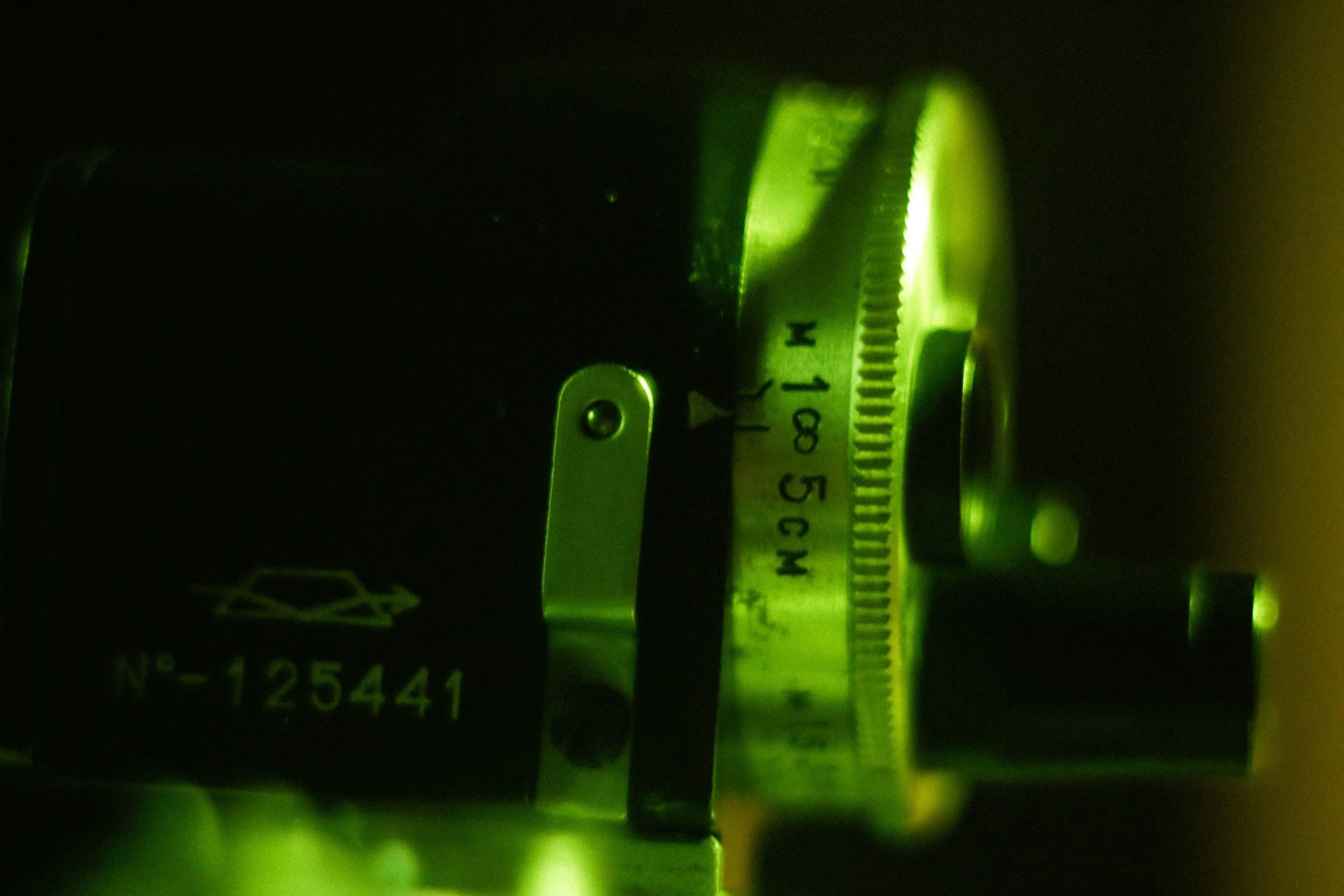 Close-up of a measuring device with a green light, showing markings from 0 to 10, and a label reading 'N 425441'.