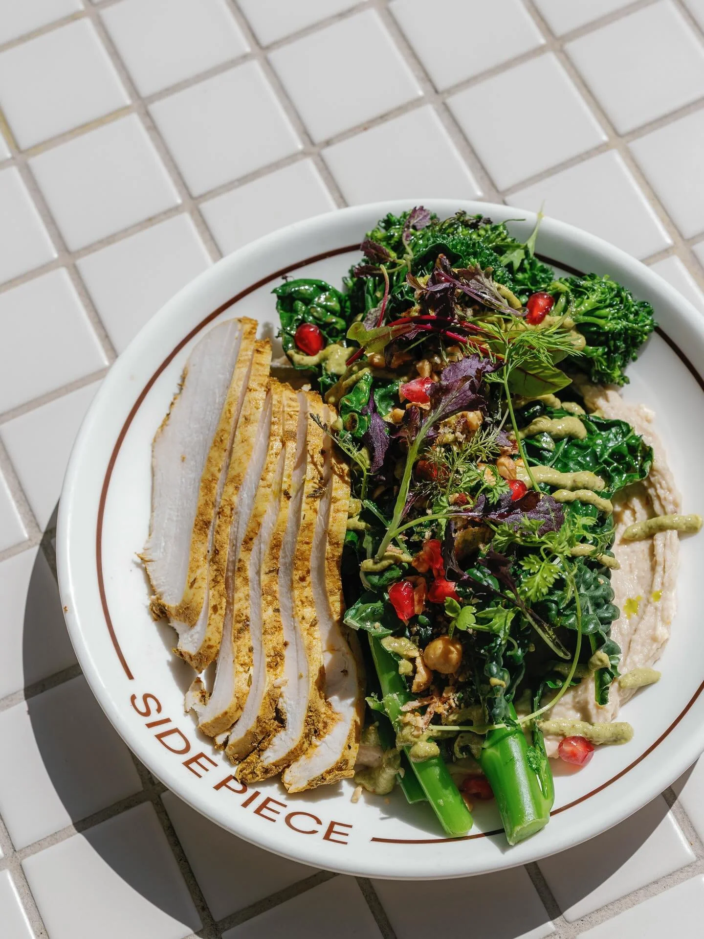 If you&rsquo;re after something fresh, the Side Piece Salad Bowl is a solid go-to - white bean and miso hummus, grilled broccolini and hazelnuts, with the option to add poached chicken, fried chicken, Manjimup trout, a soft-boiled egg or even an onio