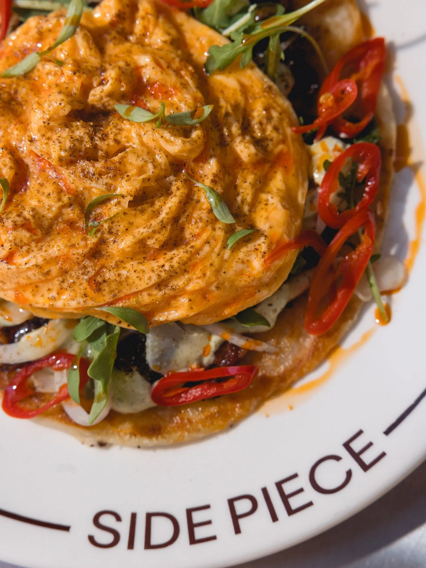 Brinjal. Slow cooked curried eggplant with folded egg,
pickled chilli &amp; flaky paratha

New at Side Piece.