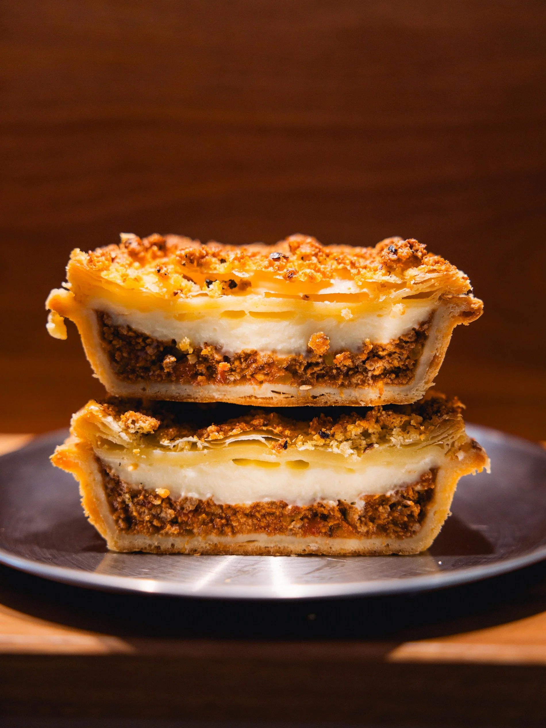 A little something to warm the hands and the soul.

Our lasagne pie is topped with silky white b&eacute;chamel and crunchy pangrattato for the perfect balance of comfort and texture.

available throughout june, until sold out each day.