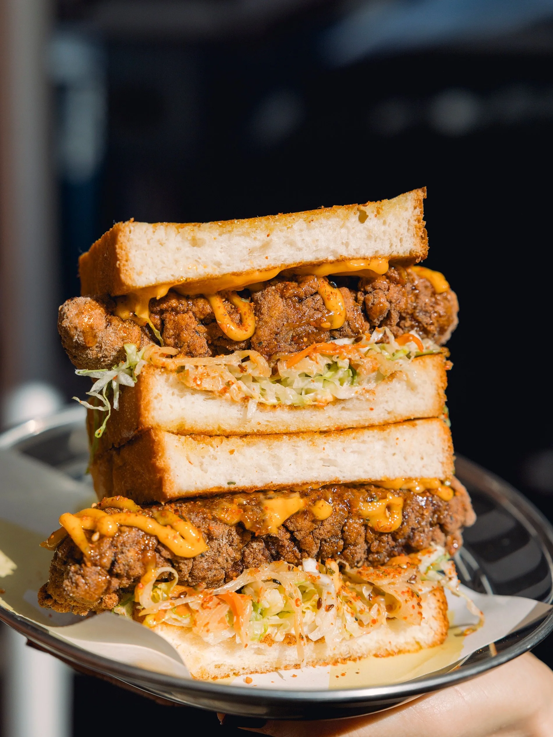 Crunchy Japanese karaage chicken, fennel kimchi, gochujang mayo and a drizzle of Szechuan hot honey, all tucked into fresh bread.

A little spicy, a little sweet, and seriously hard to put down.

Available from 10am daily in July.