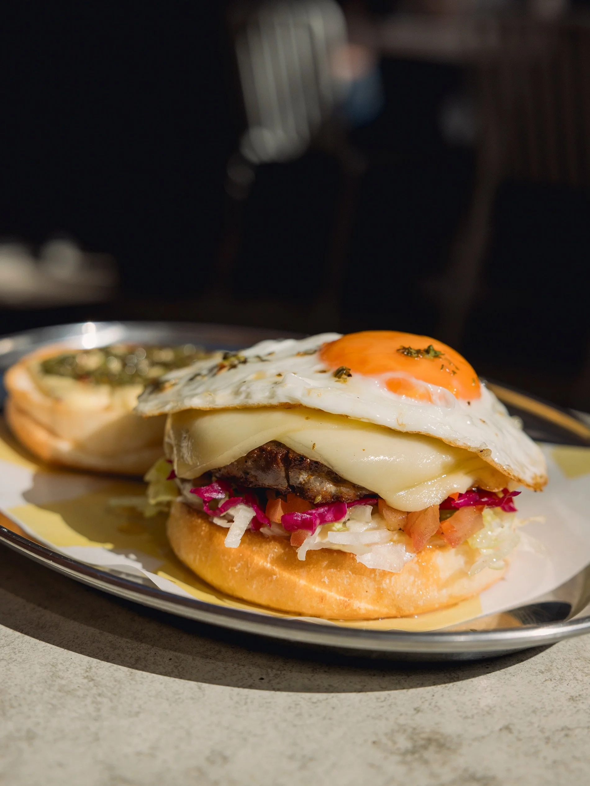 Choripan brekky muffin, 

Smoky pork patty, mustard mayo, salsa criolla, provolone, runny fried egg, and chimichurri.

All day, everyday during August