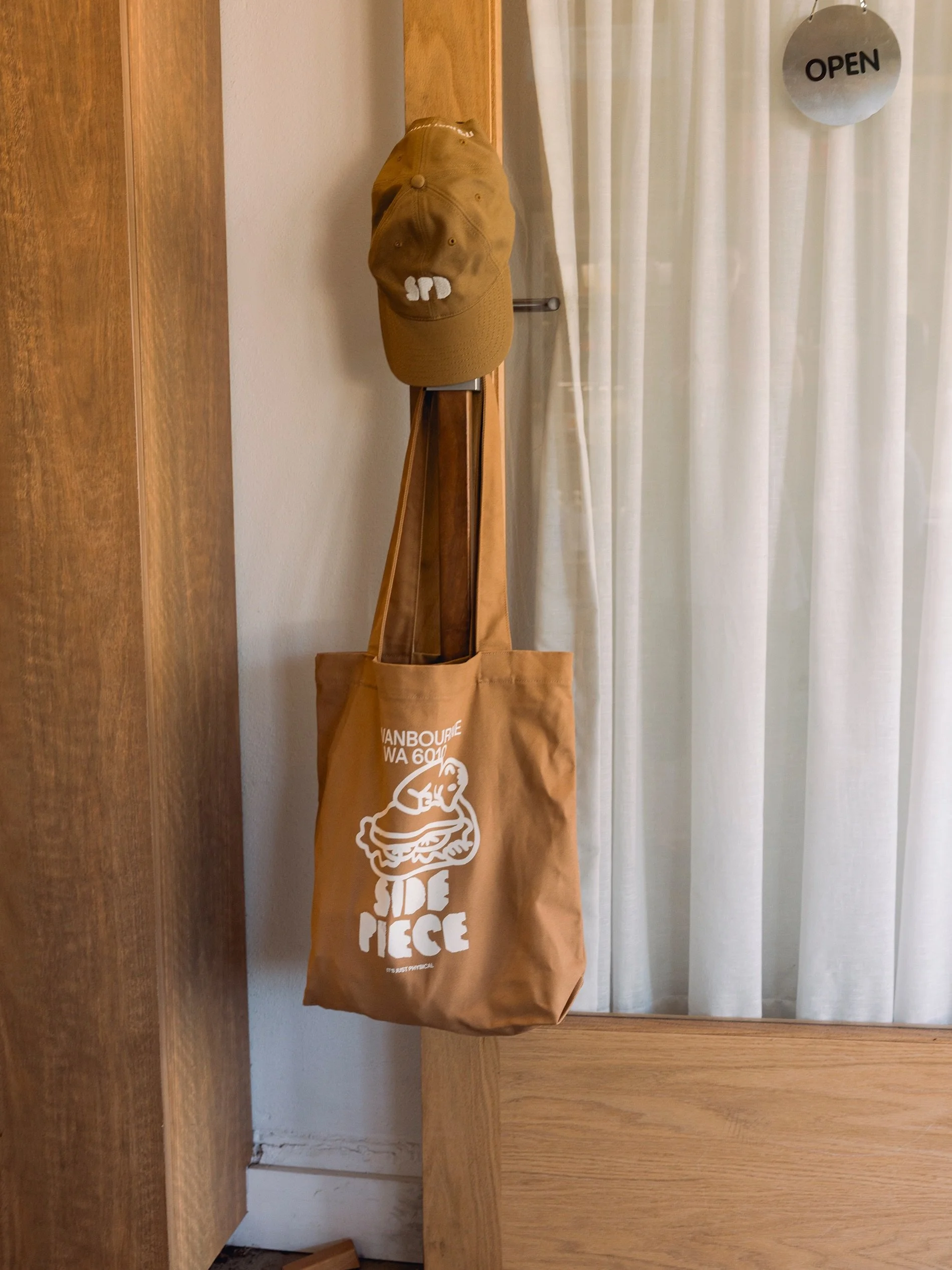 A little Side Piece for your everyday.

Caps, totes + reusable cups. Pick yours up next time you&rsquo;re in.

6:30 - 2:30 all weekend.