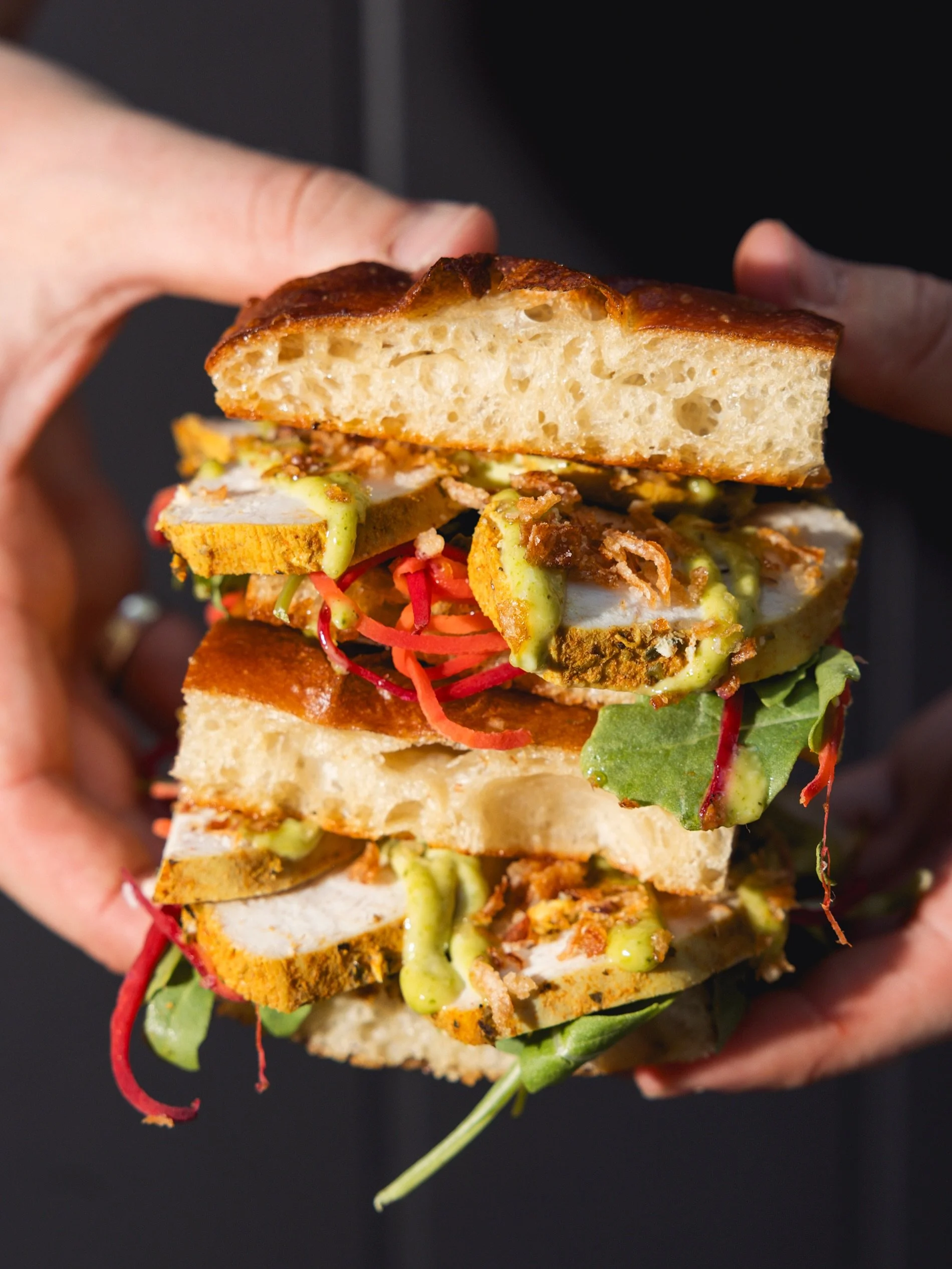 An old faithful but always hits the spot.  Our Poached Chicken Focaccia. poached chicken, herbed mayo, mango chutney &amp; pickled rainbow carrot served between sliced focaccia

Available dine-in or takeaway.