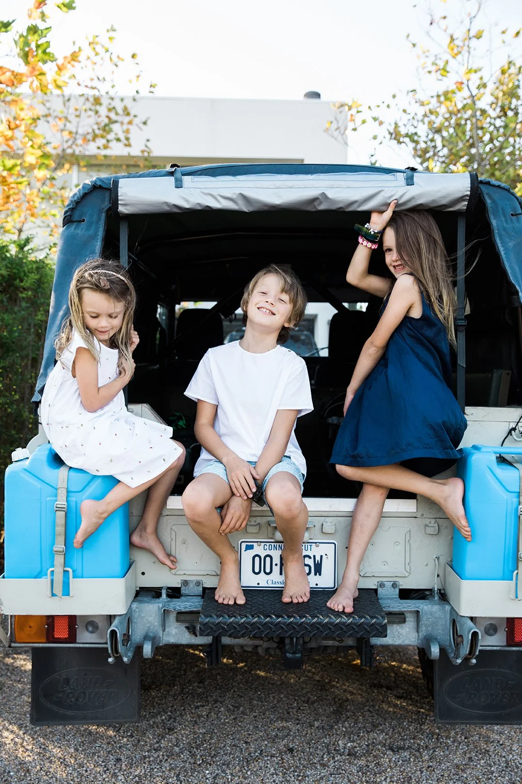 Lifestyle family photographer kids in defender.jpg