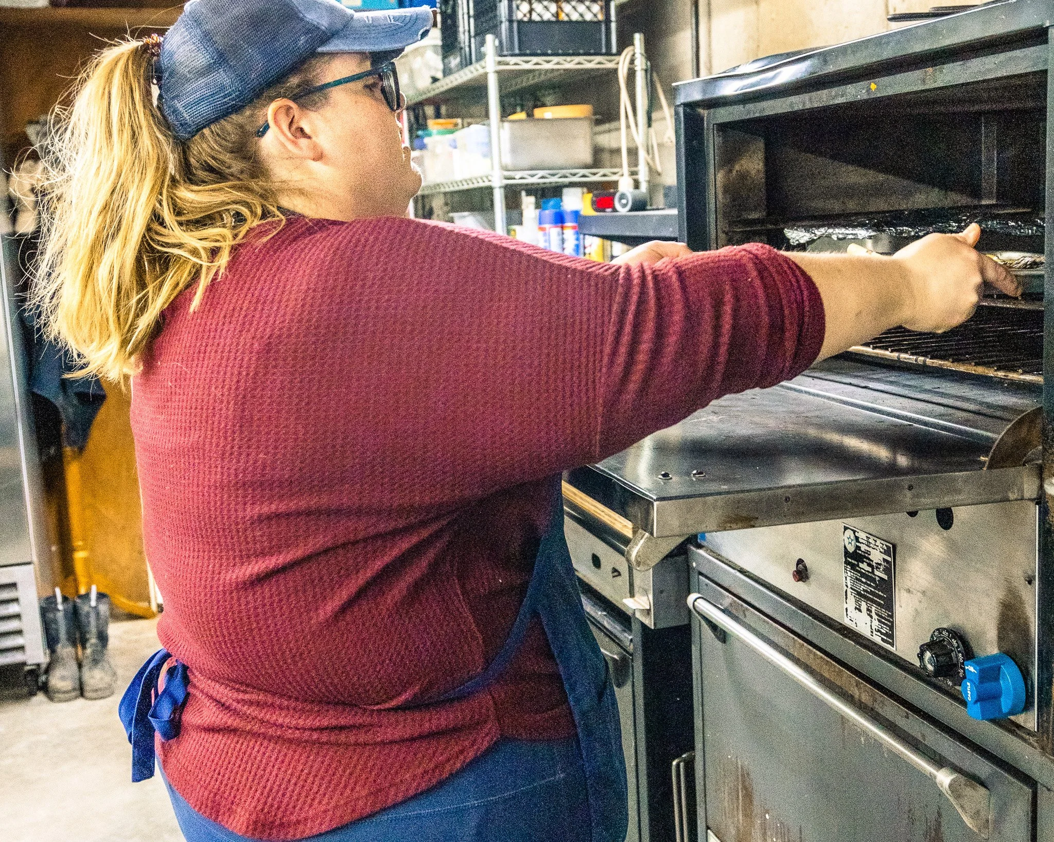 Niki of Boki's Kitchen preparing a meal for catering service.